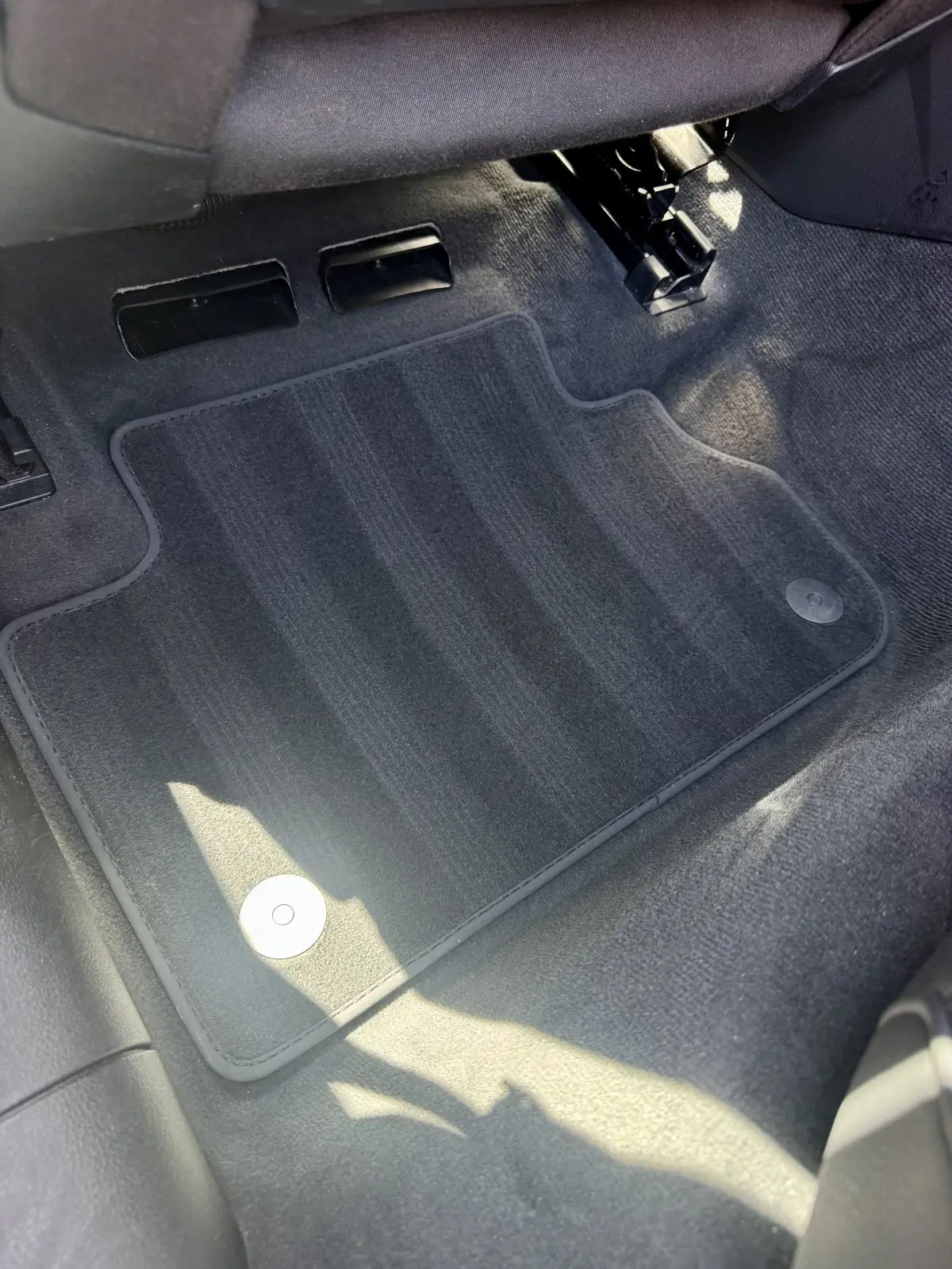 Dry front footwell carpet and fabric floor mat after a car detail