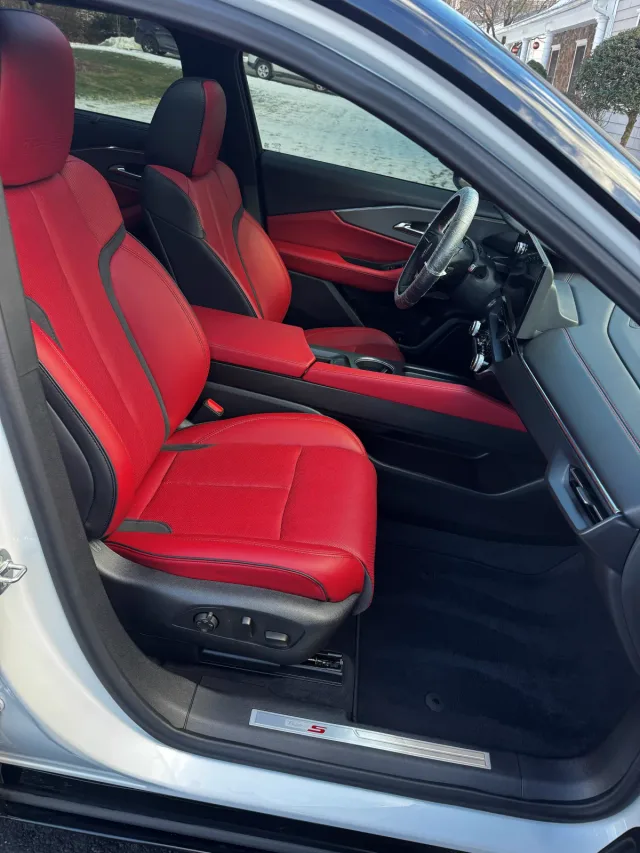 Red leather front seats and console after an interior detail