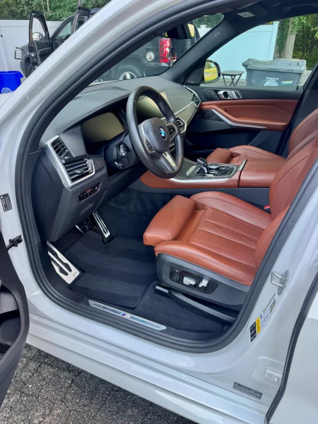 BMW X5 cognac leather driver seat and door after an interior detail